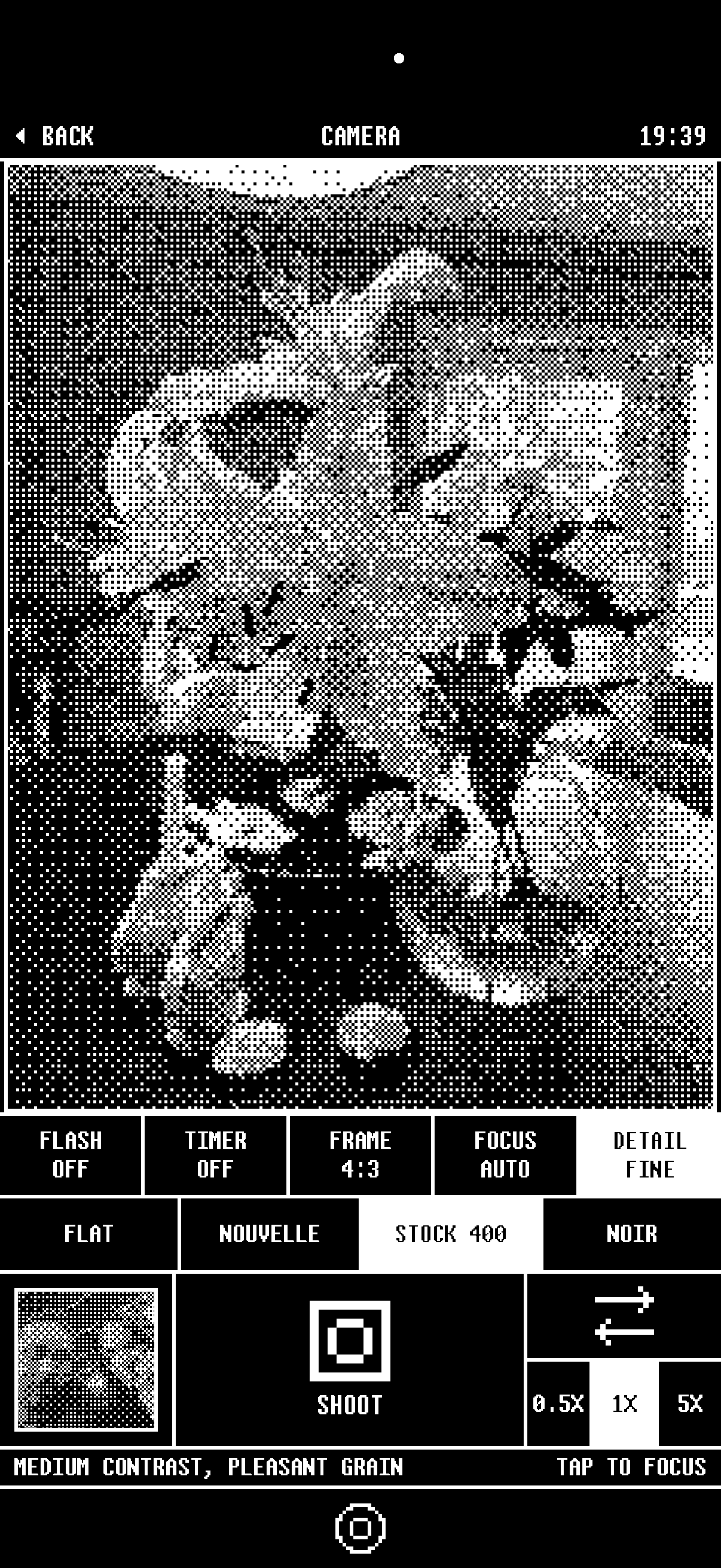 The 1bit camera on iPhone showing a portrait rendered live in black and white pixels.